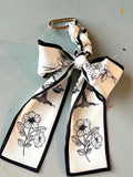 Skinny scarf bag accessory